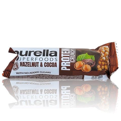Baton proteinowy Guiltfree Purella Superfoods o smaku orzecha laskowego i kakao w brązowym opakowaniu